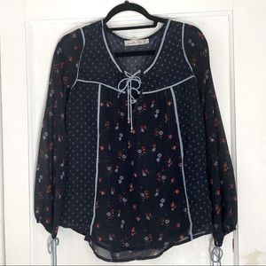 Navy blue blouse with flowers. Light blue tie strings at neck and sleeves